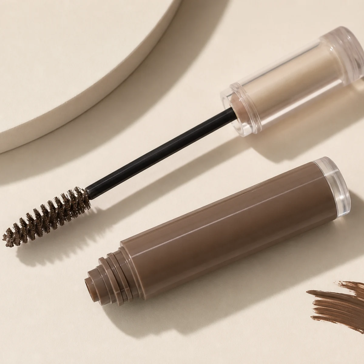 Brow gel wands and neutral makeup tools on clean vanity surface